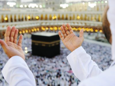 Muslim praying at Mekkah with hands up Islamic Holy Place in Mecca, Saudi Arabia